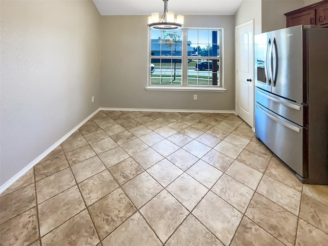 kitchen with stainless steel fridge, vaulted ceiling, light tile patterned flooring, decorative light fixtures, and an inviting chandelier