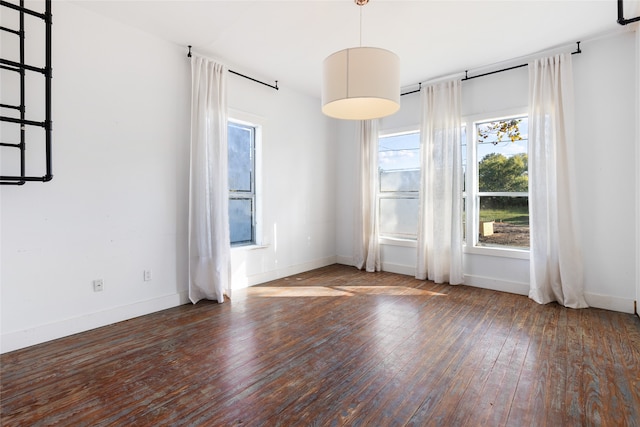 empty room with dark hardwood / wood-style flooring