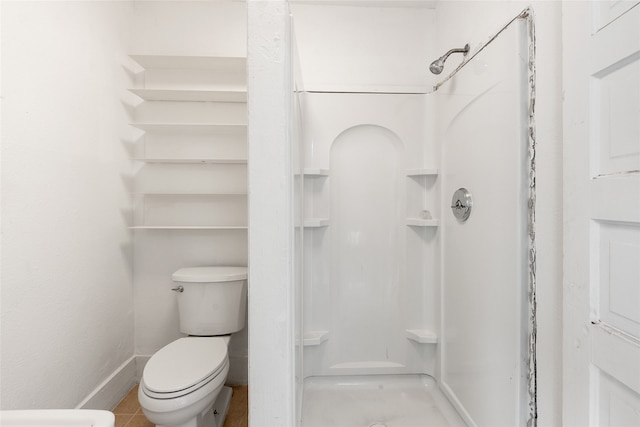 bathroom with a shower, toilet, and tile patterned flooring