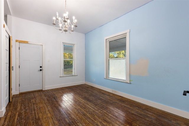 interior space featuring an inviting chandelier and dark wood-type flooring