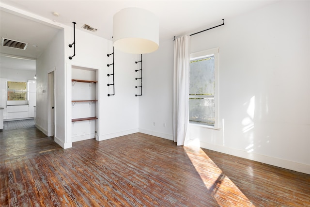 unfurnished room featuring dark wood-type flooring