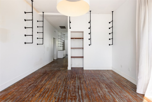 unfurnished room with dark hardwood / wood-style floors