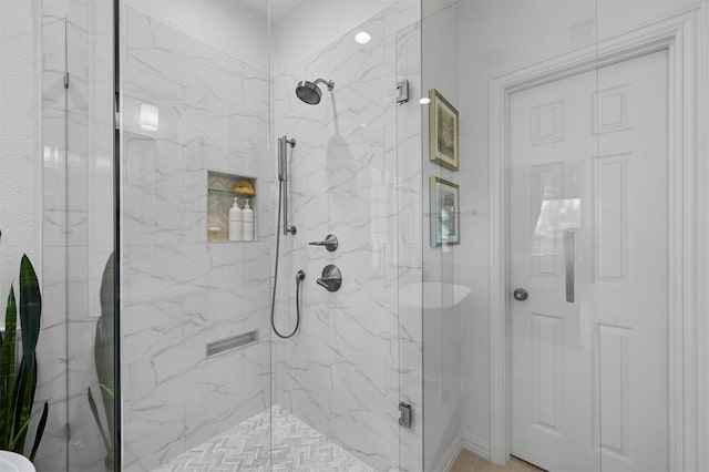 bathroom with a shower with shower door