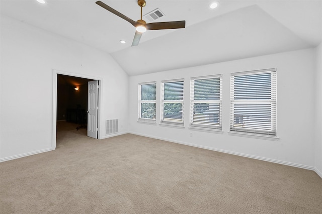 carpeted spare room with vaulted ceiling and ceiling fan