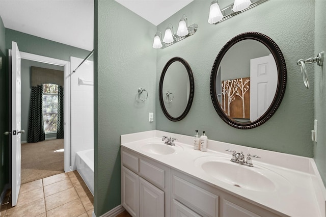 bathroom featuring tile patterned floors, vanity, and tub / shower combination