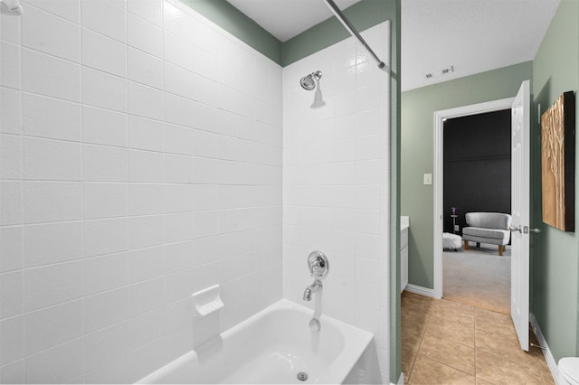 bathroom featuring tile patterned flooring, vanity, and tiled shower / bath