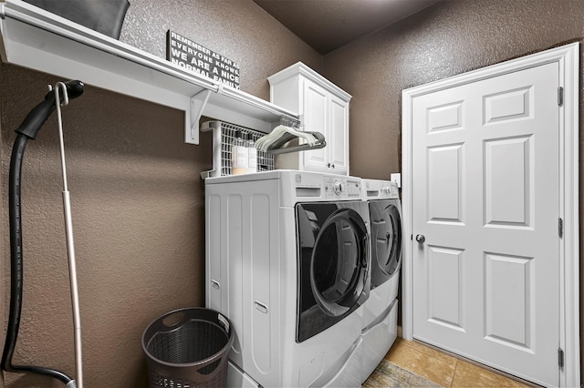 laundry room featuring cabinets and independent washer and dryer