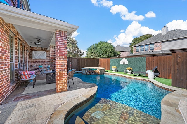 view of swimming pool featuring an in ground hot tub, ceiling fan, and a patio area