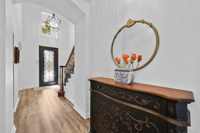 entrance foyer featuring an inviting chandelier and light hardwood / wood-style floors