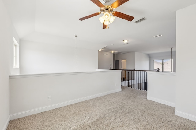 carpeted spare room with ceiling fan