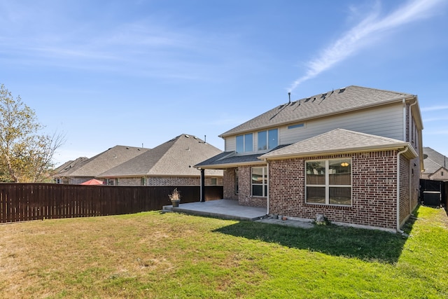 back of house with a yard and a patio area