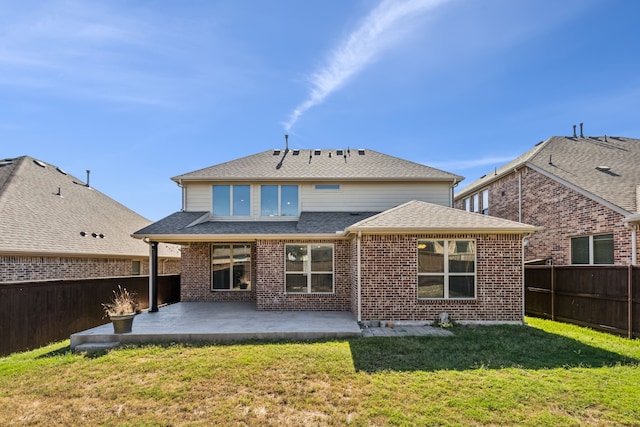 back of house featuring a patio and a lawn