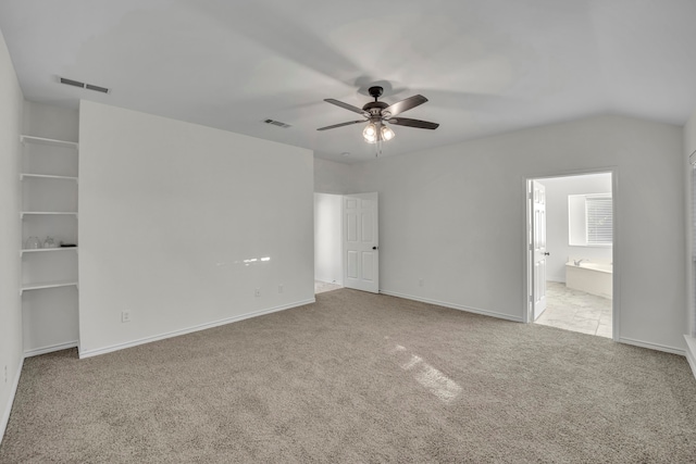 unfurnished bedroom with ensuite bath, ceiling fan, and light colored carpet