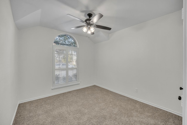 empty room featuring carpet flooring, ceiling fan, and lofted ceiling