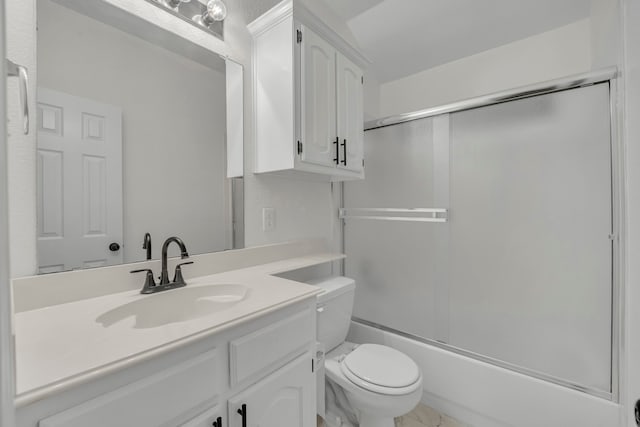 full bathroom featuring vanity, toilet, and shower / bath combination with glass door