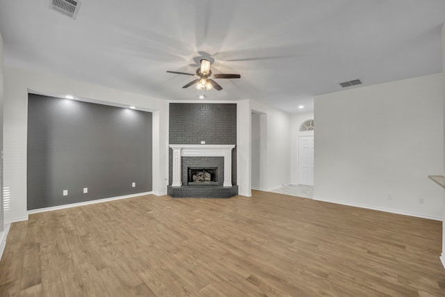 unfurnished living room with a fireplace, light hardwood / wood-style floors, and ceiling fan