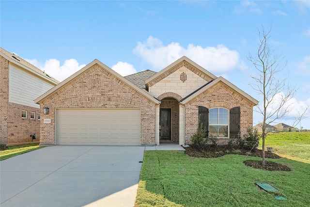 view of front of property with a front yard and a garage