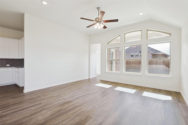 unfurnished living room with lofted ceiling, ceiling fan, and hardwood / wood-style flooring