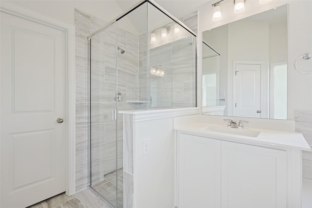 bathroom with vanity and a shower with shower door