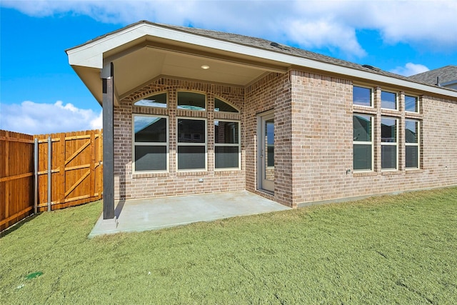 doorway to property featuring a lawn and a patio