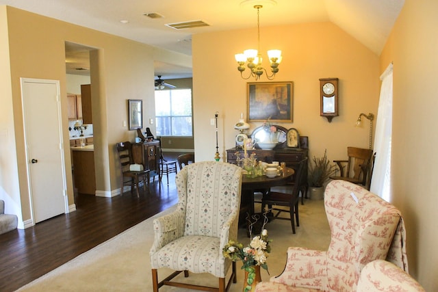 sitting room with baseboards, visible vents, lofted ceiling, wood finished floors, and a notable chandelier