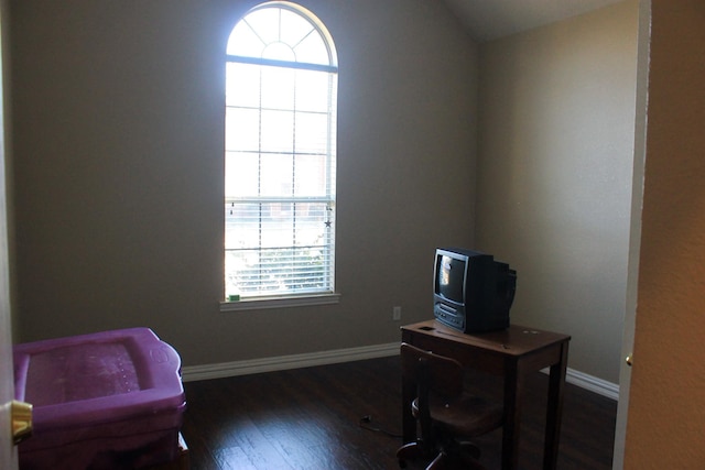 office space with vaulted ceiling, baseboards, and wood finished floors