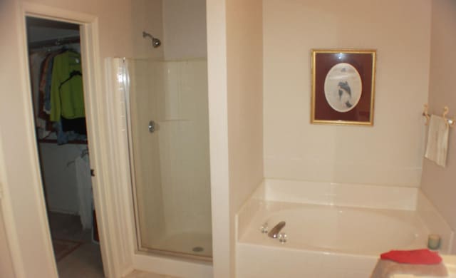 bathroom featuring independent shower and bath and tile patterned flooring