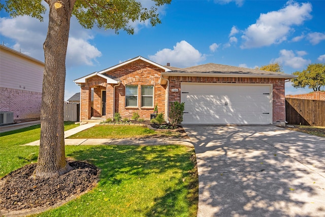 ranch-style home featuring a front yard, central AC unit, and a garage