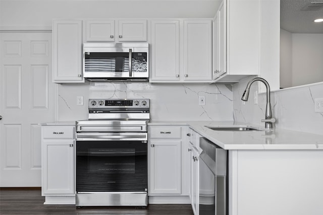 kitchen with white cabinetry, appliances with stainless steel finishes, and sink