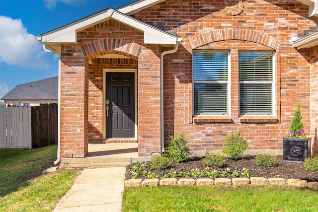 entrance to property with a yard