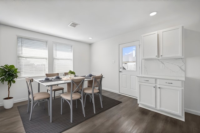 dining area with dark hardwood / wood-style flooring