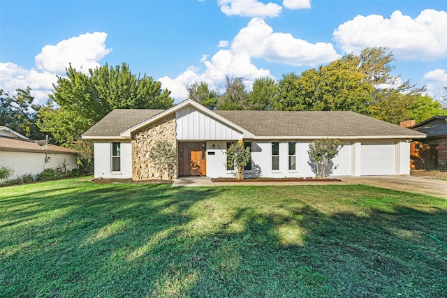 view of front of property with a front lawn and a garage