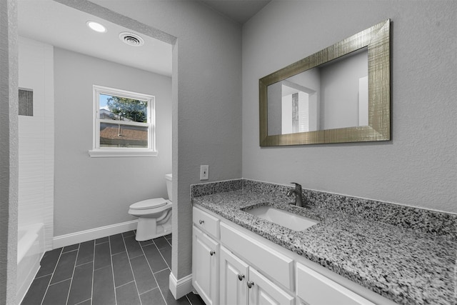 bathroom featuring vanity, toilet, and tile patterned floors