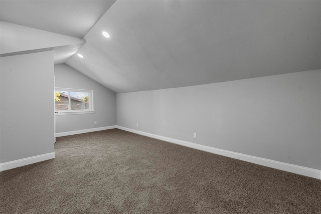 additional living space with vaulted ceiling and carpet floors