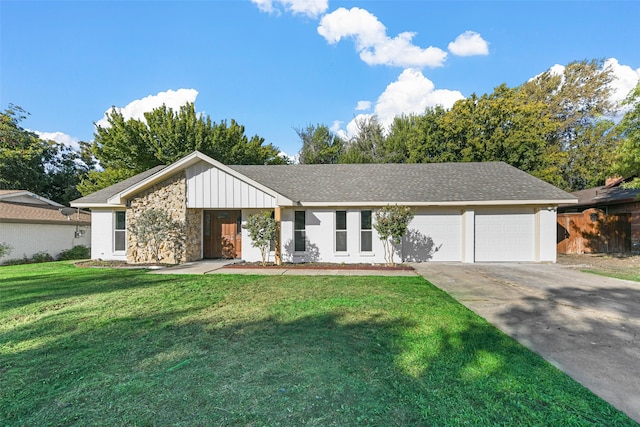 view of front of house with a garage and a front lawn