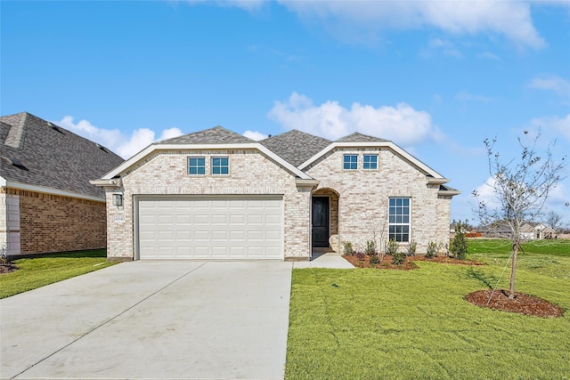 view of front of home with a garage and a front yard