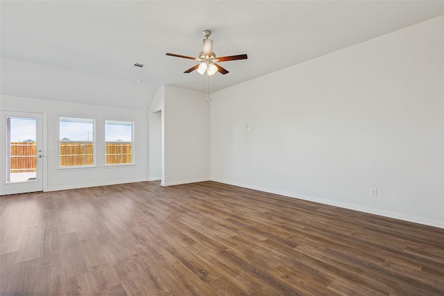 empty room with lofted ceiling, ceiling fan, and dark hardwood / wood-style flooring