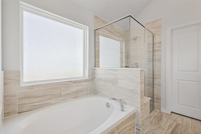 bathroom featuring vaulted ceiling and plus walk in shower