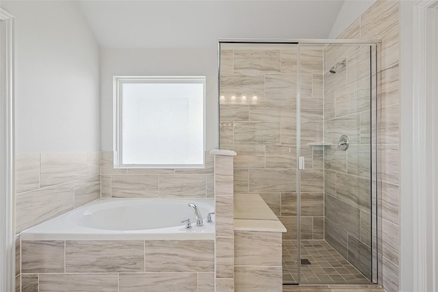 bathroom featuring vaulted ceiling and plus walk in shower