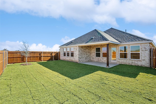 rear view of property featuring a patio and a lawn