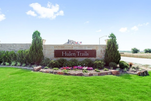 community / neighborhood sign with a lawn