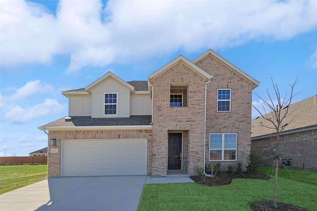 view of front of house featuring a garage and a front lawn