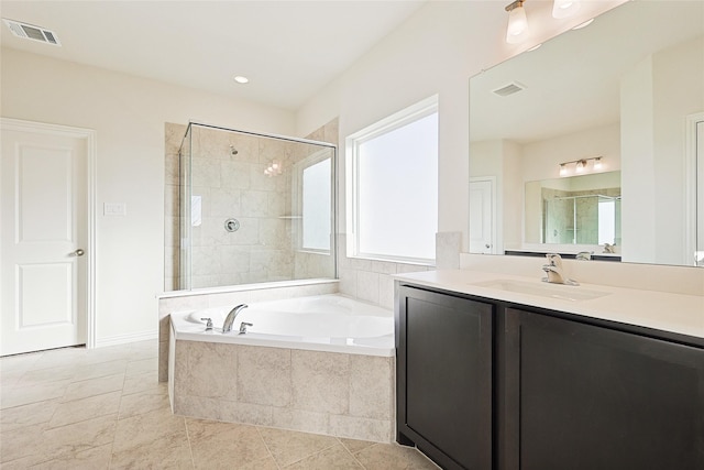 bathroom featuring vanity and separate shower and tub