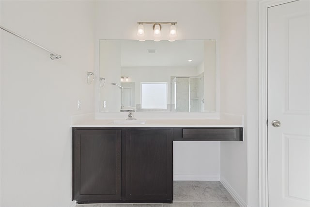 bathroom with vanity, an enclosed shower, and tile patterned flooring