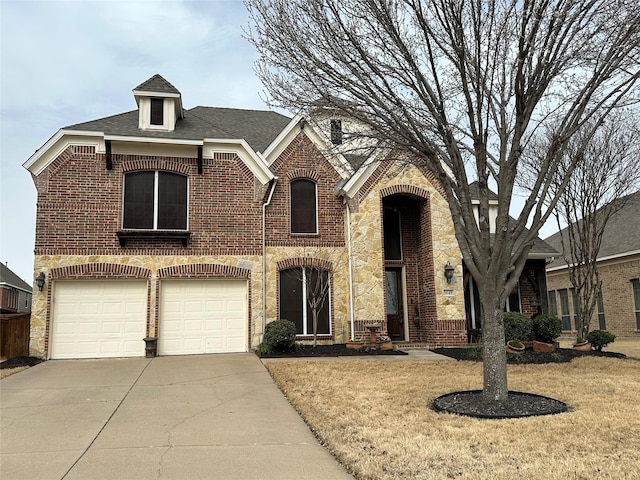 view of front of house featuring a garage, a front yard, concrete driveway, and brick siding