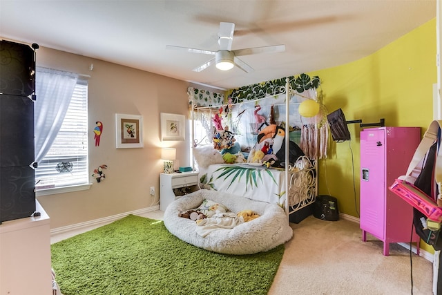 carpeted bedroom with a ceiling fan, multiple windows, and baseboards