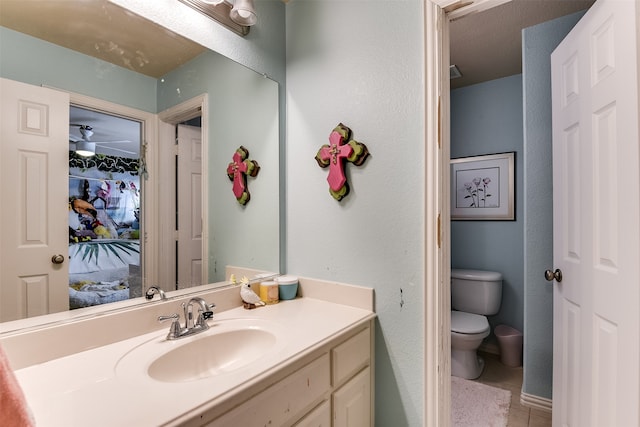 bathroom with vanity, toilet, and tile patterned flooring