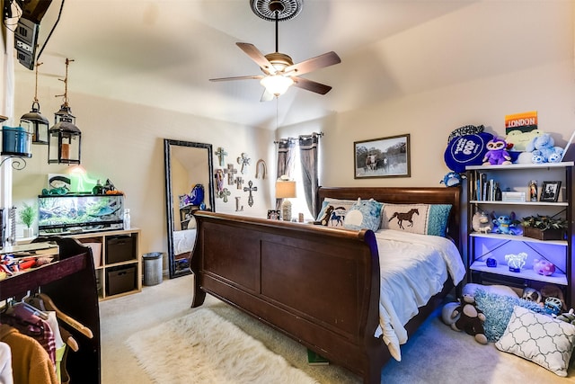 bedroom featuring lofted ceiling, ceiling fan, and light carpet