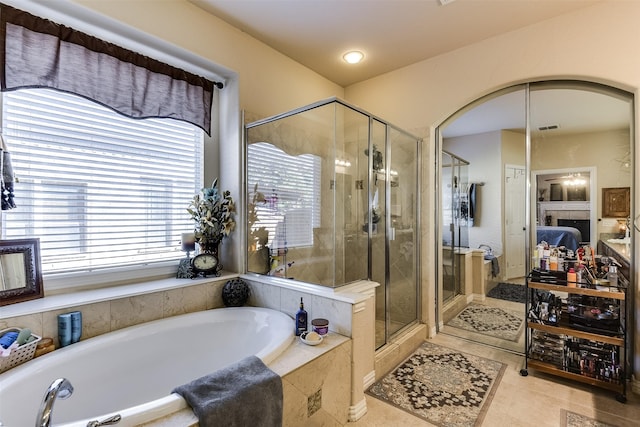 3048 S Camino Lagos, Grand Prairie, TX 75054 - ensuite bathroom featuring plenty of natural light, a bath, a stall shower, and tile patterned flooring