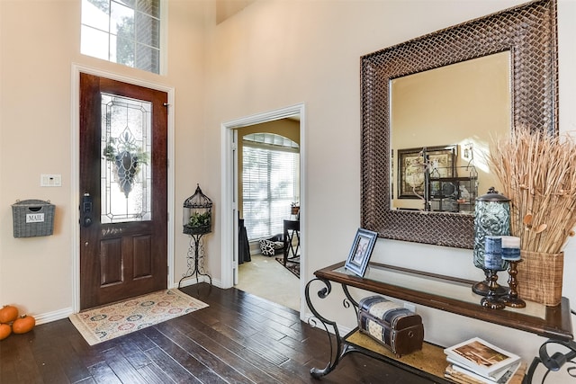 foyer with hardwood / wood-style floors and baseboards